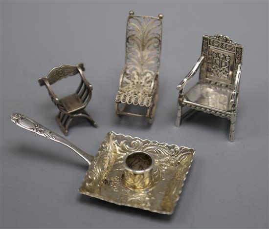 An Edwardian silver miniature arm chair, Birmingham, 1903, a filigree rocking chair, a Dutch white metal chamberstick etc.